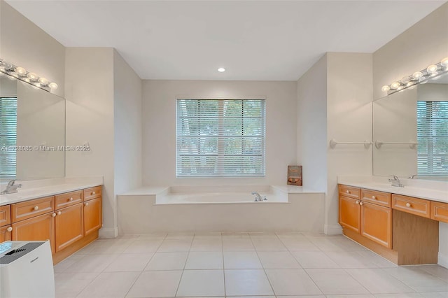 bathroom featuring vanity, tile patterned floors, and a tub to relax in