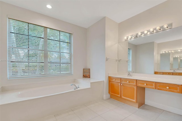 bathroom with vanity, tile patterned floors, and a tub to relax in