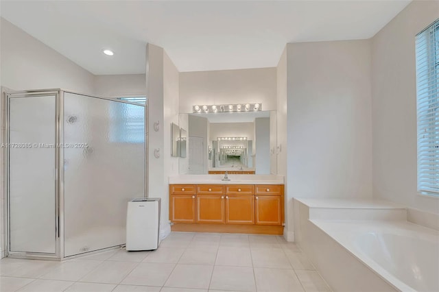 bathroom featuring tile patterned flooring, shower with separate bathtub, plenty of natural light, and vanity