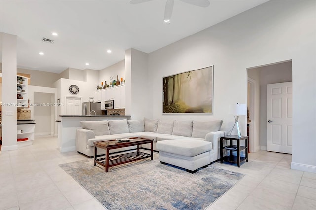 living room featuring light tile patterned floors and ceiling fan