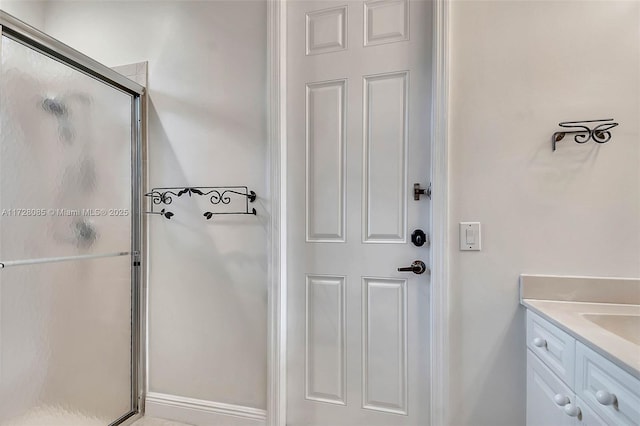 bathroom with vanity and a shower with shower door