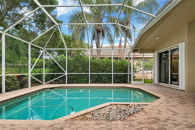 view of pool featuring a patio and glass enclosure