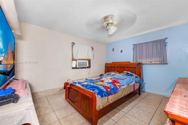 tiled bedroom with ceiling fan, cooling unit, and a textured ceiling