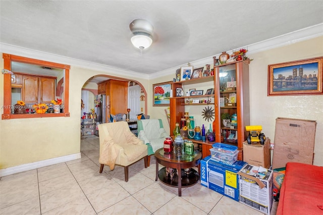 living area with light tile patterned floors and crown molding