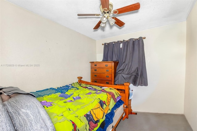 carpeted bedroom with ceiling fan and a textured ceiling