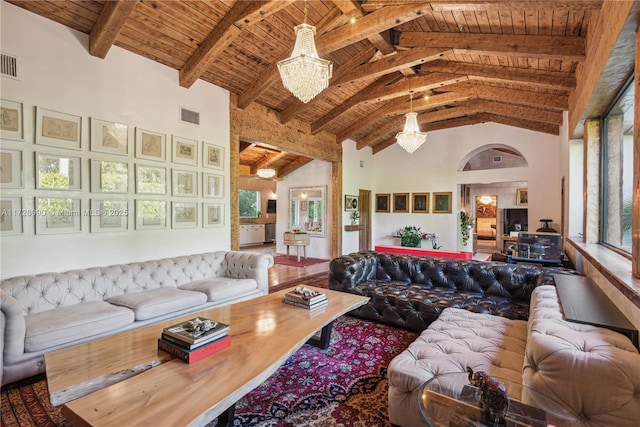 living area with beam ceiling, visible vents, high vaulted ceiling, and wooden ceiling