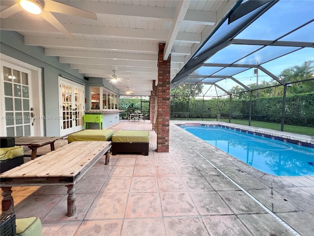 view of swimming pool featuring french doors, a lanai, and a patio