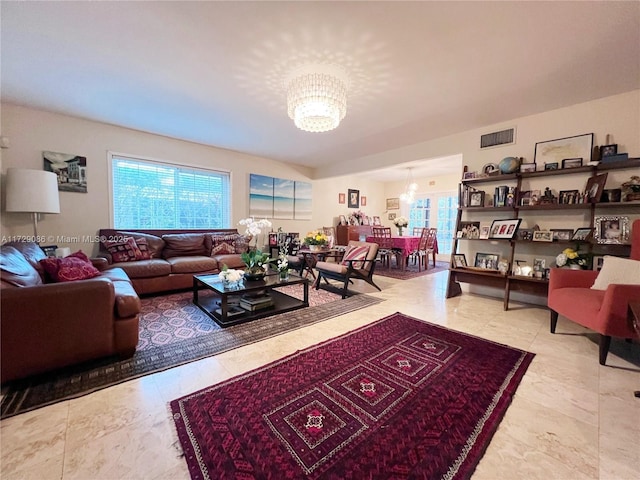 living room featuring a notable chandelier