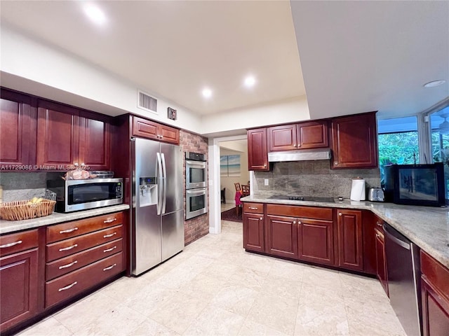 kitchen featuring stainless steel appliances and decorative backsplash