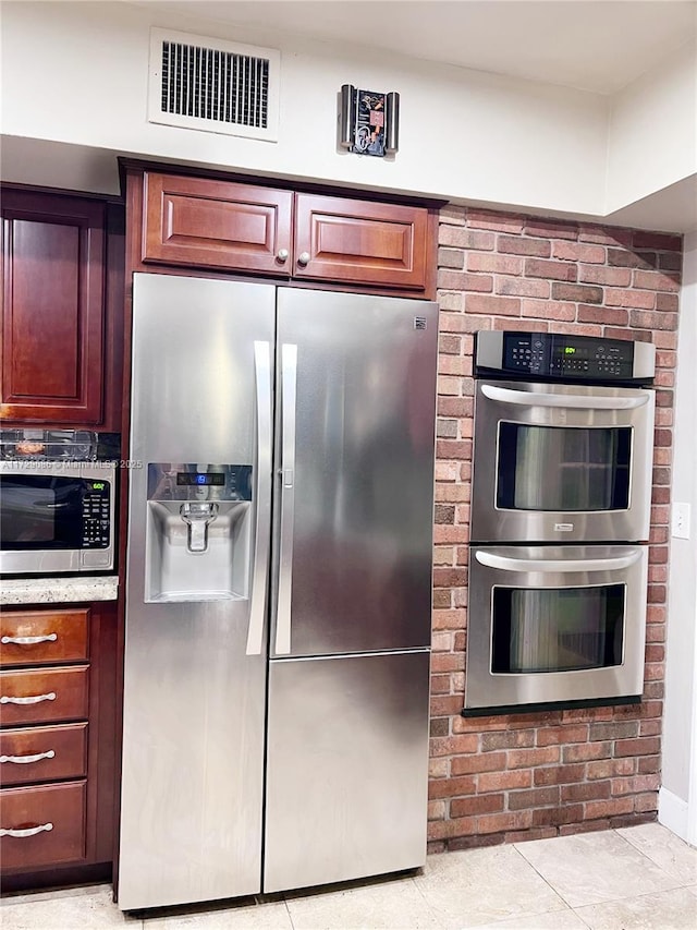 kitchen with appliances with stainless steel finishes and light tile patterned floors