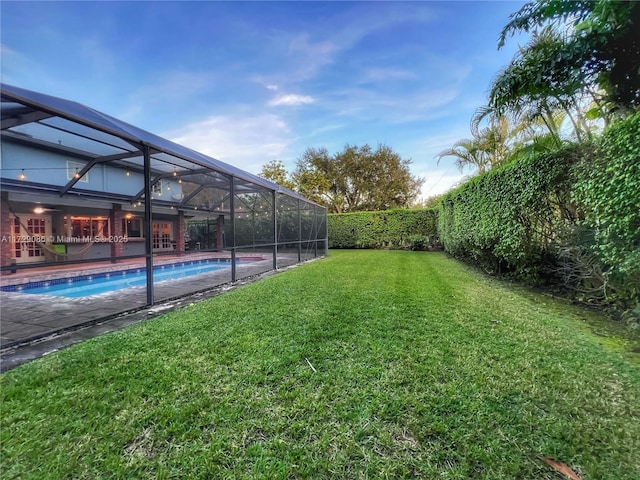 view of yard with a lanai and a fenced in pool