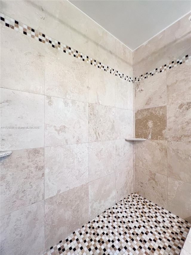 bathroom with tiled shower