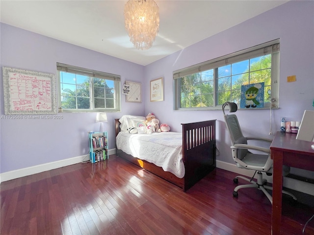 bedroom with wood-type flooring and a chandelier