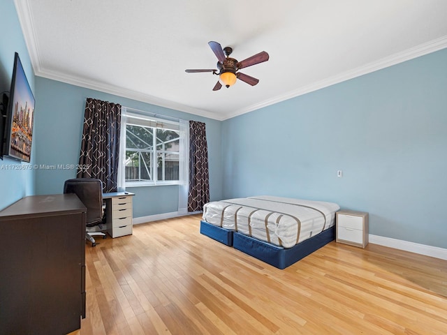 bedroom featuring ornamental molding, baseboards, ceiling fan, and hardwood / wood-style floors