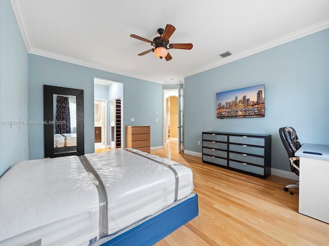 bedroom featuring visible vents, ornamental molding, light wood-style flooring, and baseboards