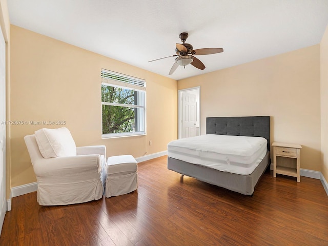 bedroom with ceiling fan, baseboards, and wood finished floors