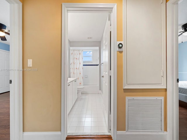 corridor with visible vents and light tile patterned floors