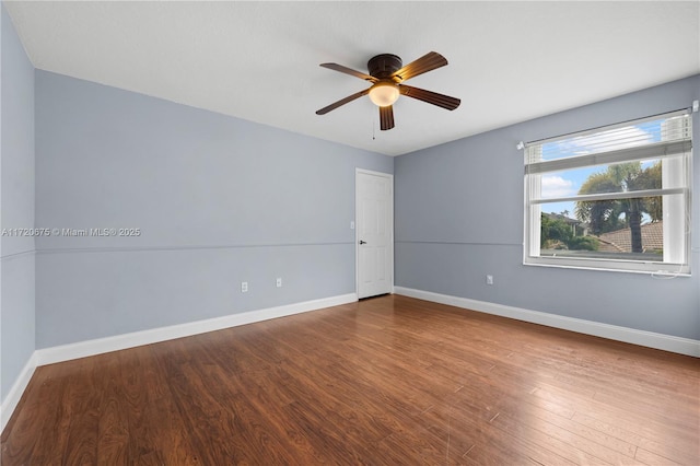 empty room featuring ceiling fan, baseboards, and wood finished floors