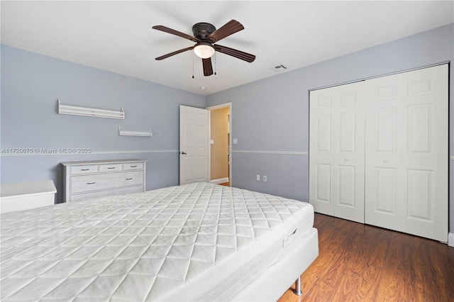 bedroom with a ceiling fan, a closet, visible vents, and wood finished floors