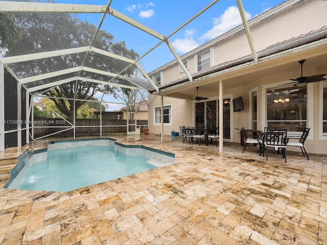 view of pool with a ceiling fan, outdoor dining space, a lanai, and a patio