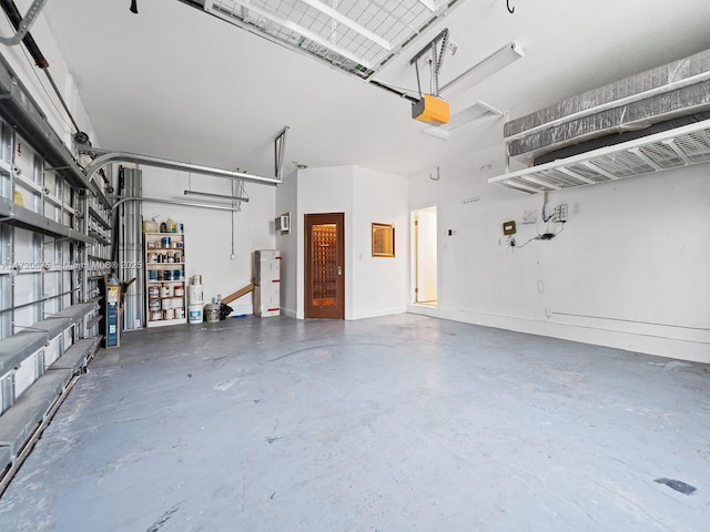 garage with a garage door opener and baseboards