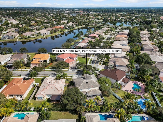 birds eye view of property featuring a water view and a residential view