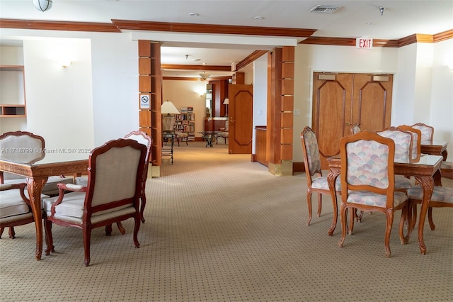 carpeted dining area with crown molding