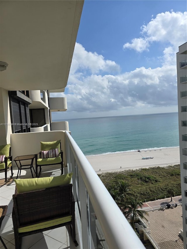 balcony with a view of the beach and a water view