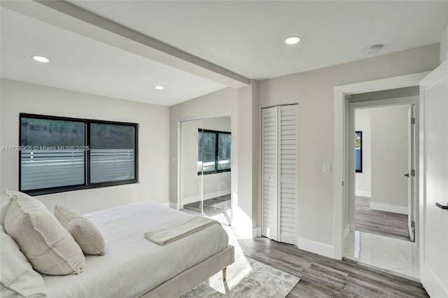 bedroom featuring access to exterior and hardwood / wood-style floors