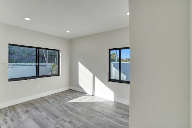 spare room with light hardwood / wood-style floors