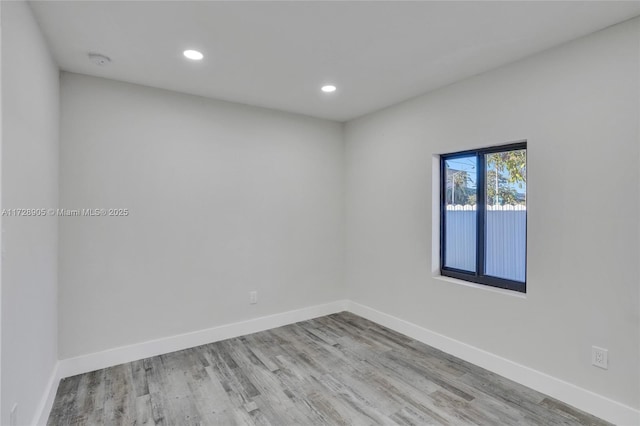 empty room with light hardwood / wood-style flooring