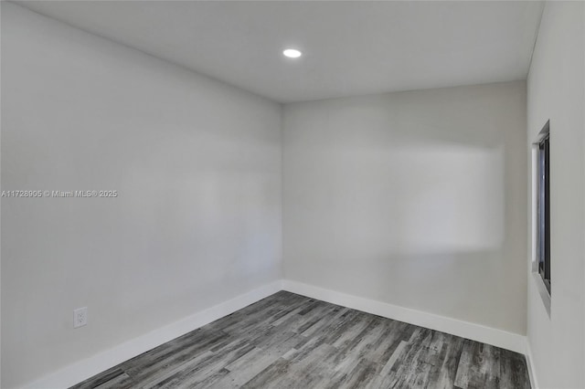 unfurnished room with hardwood / wood-style floors