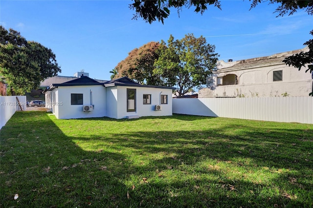 back of house with a lawn