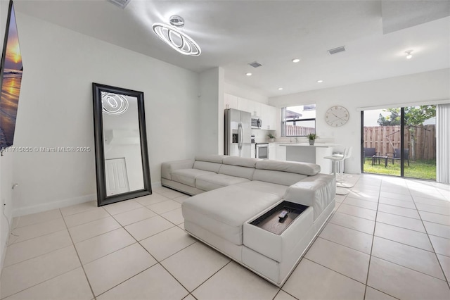 living room with light tile patterned floors and sink