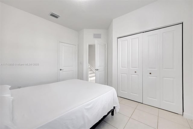 bedroom featuring light tile patterned floors and a closet