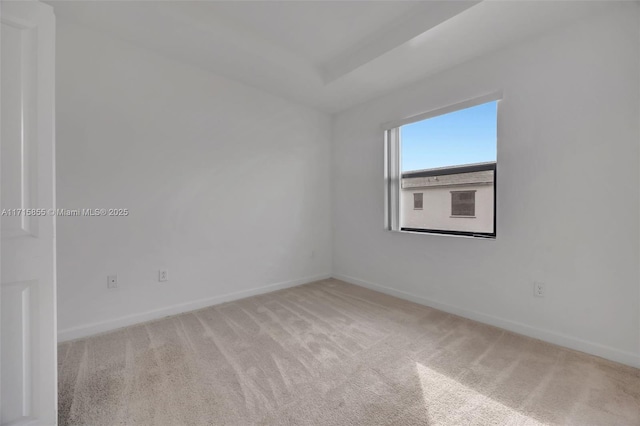 spare room with light colored carpet