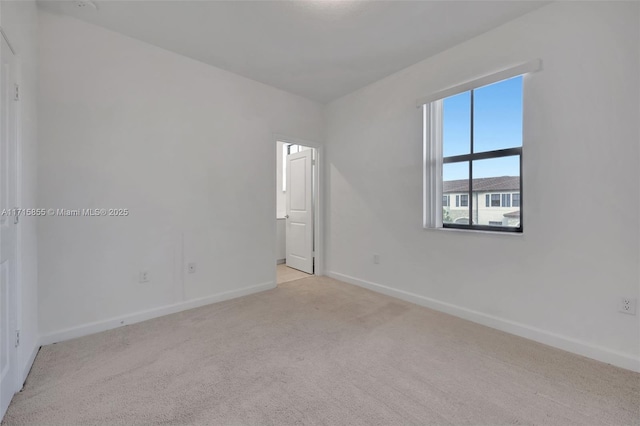 spare room with light colored carpet