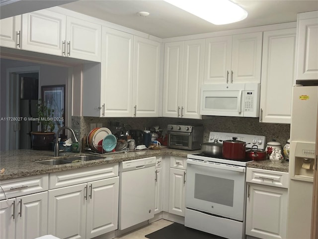 kitchen featuring sink, white appliances, and white cabinets