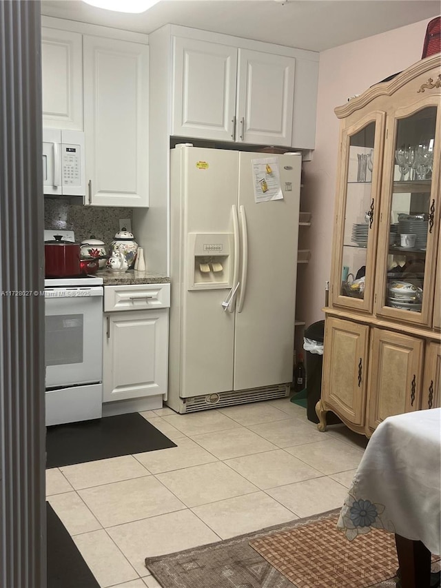 kitchen featuring white cabinetry, white appliances, light tile patterned floors, and tasteful backsplash