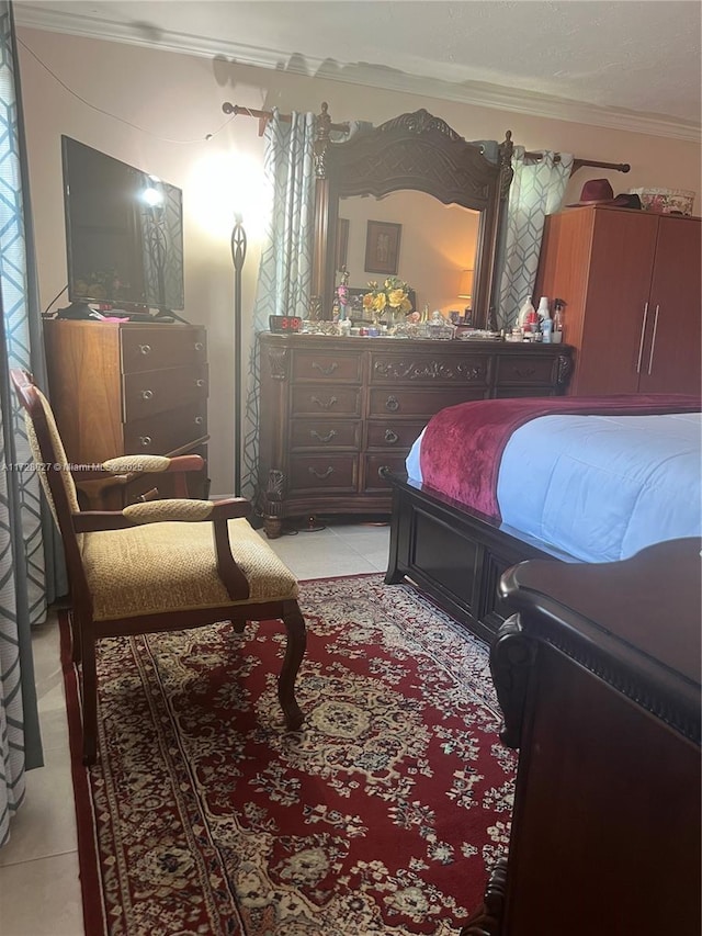 bedroom with light tile patterned floors and ornamental molding