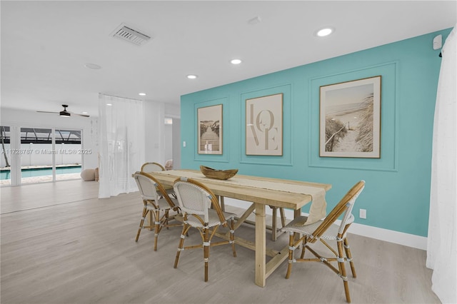 dining room with ceiling fan and light wood-type flooring