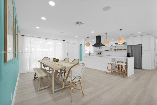 dining space with light hardwood / wood-style flooring