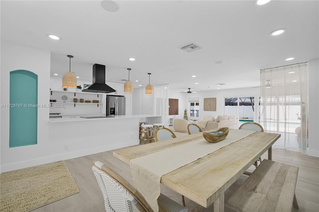 dining area featuring ceiling fan and light hardwood / wood-style flooring