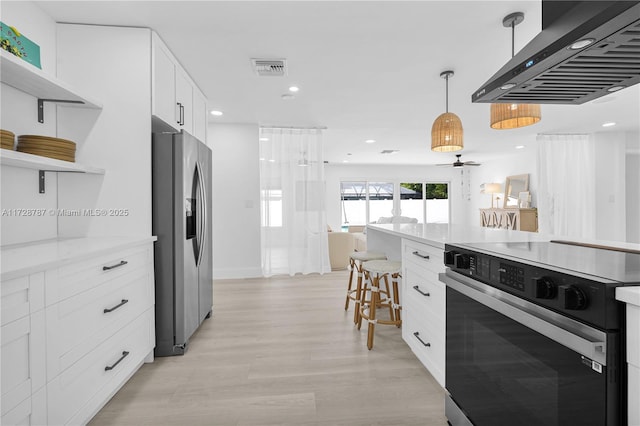 kitchen featuring stainless steel refrigerator with ice dispenser, electric range oven, island exhaust hood, and white cabinets