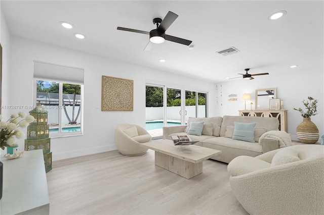 living room with ceiling fan, a healthy amount of sunlight, and light hardwood / wood-style flooring