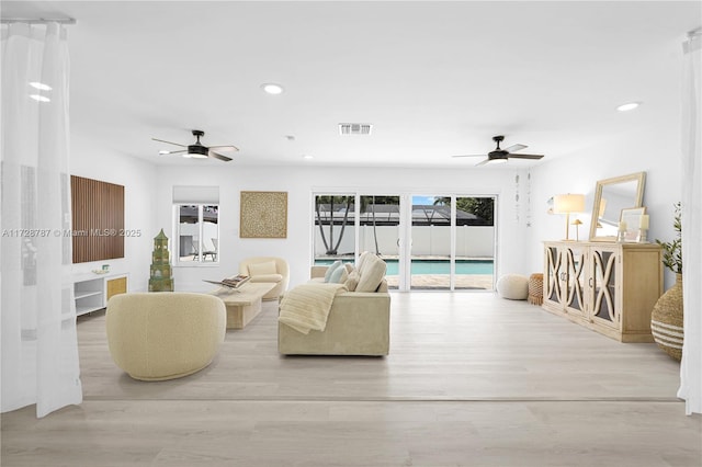 living room with ceiling fan and light hardwood / wood-style floors