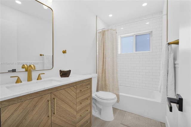 full bathroom with vanity, shower / bath combo, and toilet