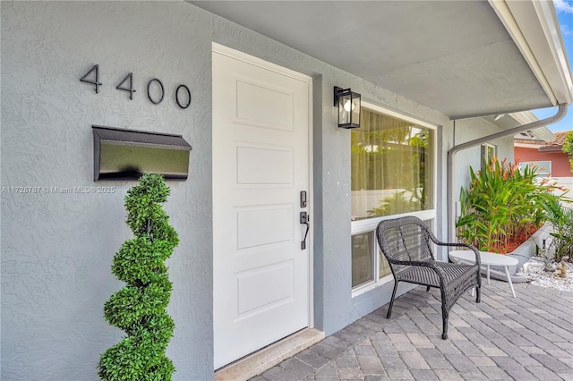 doorway to property featuring a porch