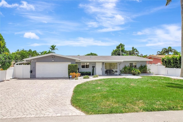 single story home featuring a garage and a front lawn