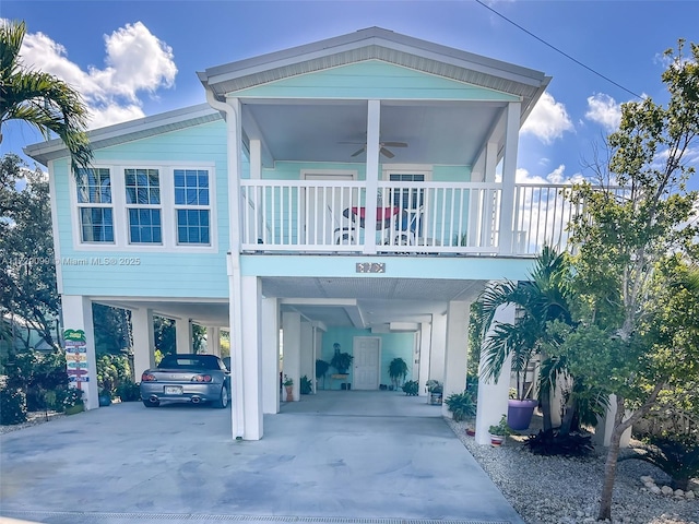 view of front of house featuring ceiling fan and a carport